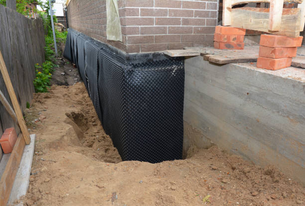 Happy homeowners after waterproofing job in Norvell
